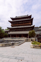 Fototapeta premium Chinese pagoda style building with tiled roofs stone base and symmetrical layout in Gubei Town China. Vertical photo