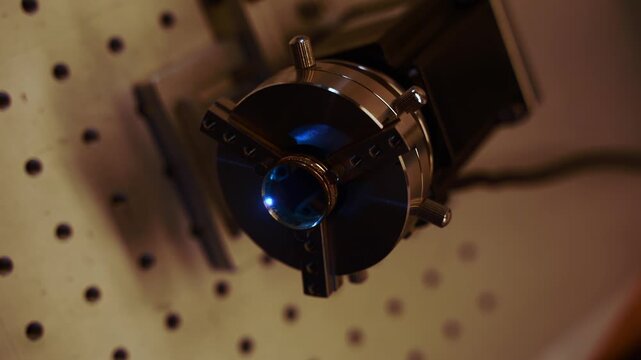 Jeweler performing precision laser engraving on a gold ring 4k video. Artisan using a laser to engrave a gold ring.