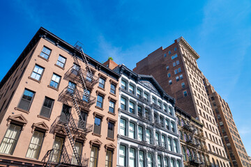 Fototapeta premium New York City buildings with exterior fire escape stairs in Manhattan urban scene