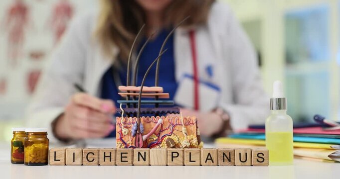Wooden cubes spell words Lichen Planus near skin model. Female dermatologist writes record evaluating rash therapy during chronic flare in lab