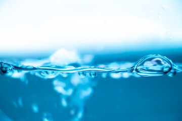 Blue water surface with air bubble and ripples, clean liquid background, freshness and purity...
