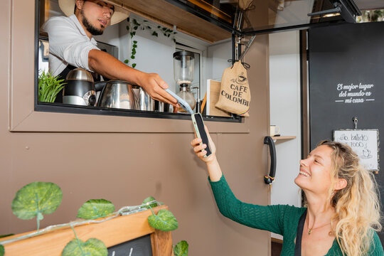 Customer enjoying payment at a coffee truck