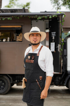 Barista posing next to a coffee truck