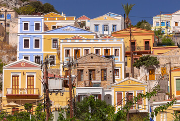 Fototapeta premium Colorful houses on hillside in Symi island Greece