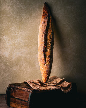 Rustic baguette on vintage wooden board