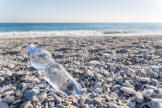 Plastic bottle pollution on a rocky beach