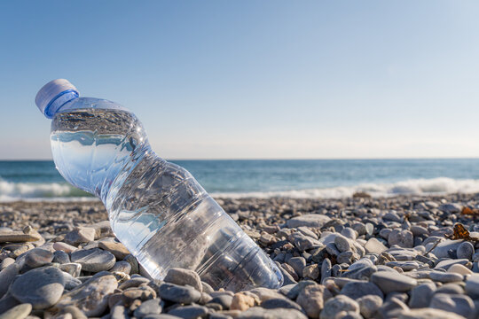Plastic bottle and ocean, highlighting pollution issue