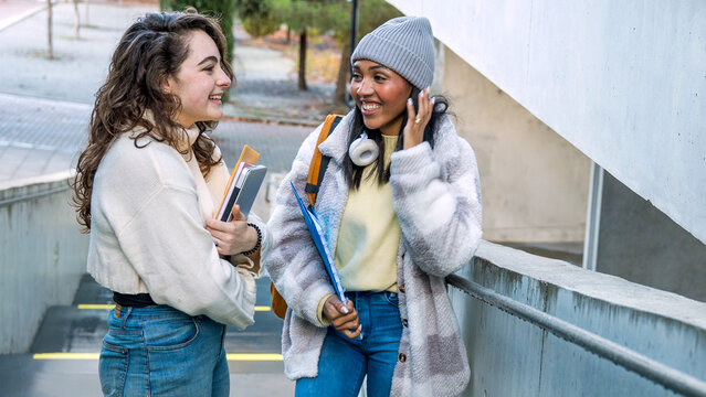College students discussing plans on campus stairs