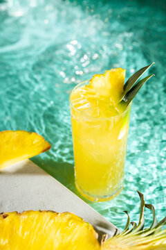 Refreshing tropical pineapple juice cocktail by the pool
