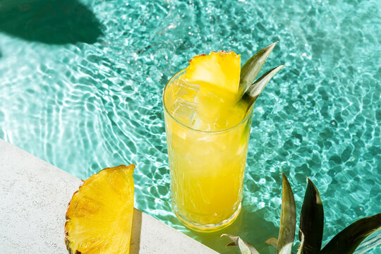 Refreshing pineapple juice cocktail by the pool