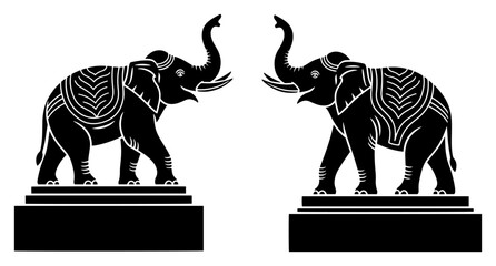 Pair of decorated ceremonial elephant silhouettes standing on pedestals with trunks up © Anna