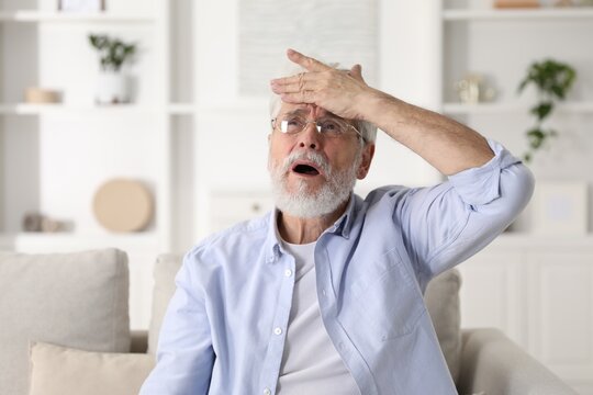 Amnesia. Senior man trying to remember something at home