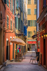 Obraz premium Al fresco tables at an outdoor restaurant in a picturesque street, Nice, France