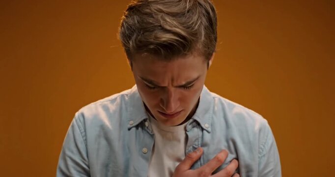 Young Man Expressing Shame and Emotional Vulnerability in Studio Portrait
