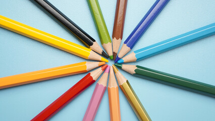A row of colored pencils are arranged in a circle