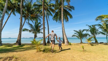 Father and son running on seaside 