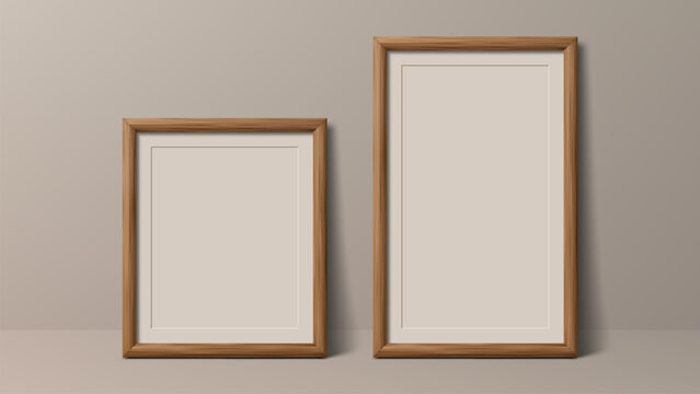 Two empty wooden picture frames with blank paper inside, standing on a shelf. Mockup for presentation of art, photograph, or poster. Minimalist and modern interior design.