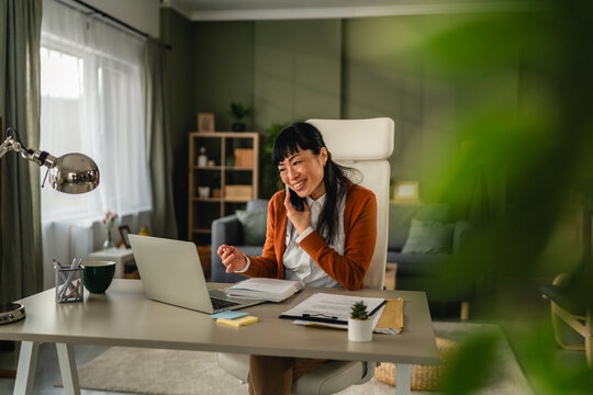 Asian woman multitasking working from home office