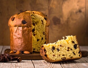 A tall, dome-shaped baked treat with raisins and candied fruit. Sliced to show interior texture, placed on a wooden board