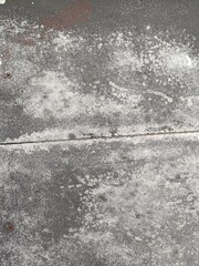 Obraz premium Grungy weathered concrete wall texture with rustic stains. Ideal for industrial backgrounds, vintage overlays, and architectural design projects seeking a raw, aged look.