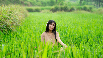 Asian woman do solo traveling to a rice field, enjoying the scenery and fresh air in the village.