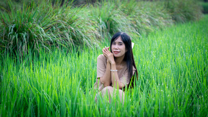 Asian woman do solo traveling to a rice field, enjoying the scenery and fresh air in the village.