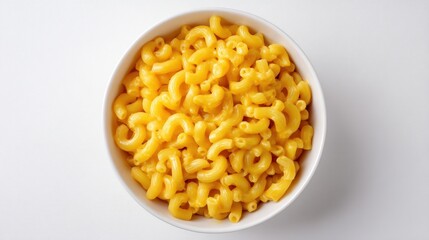 Creamy mac and cheese fills a white bowl atop a plain white surface, shot from an overhead perspective