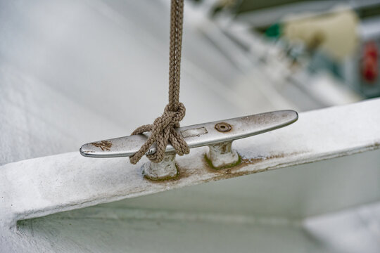 Metal deck tie point with cord for flags or light lines on a ship