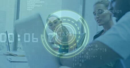 Collaborating three coworkers wearing blazers leaning over open laptop in office, with HUD overlay