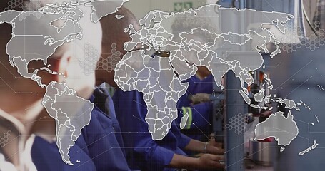 Operating control panels, factory team in blue work shirts handling parts under world map overlay