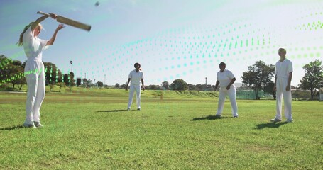 Holding wooden bat, female batter wearing white cricket kit near stumps on outfield, copy space