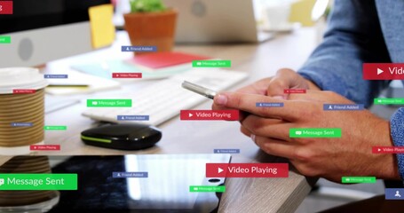 Tapping adult hands in blue shirt holding phone over wooden desk, with keyboard, alerts, copy space