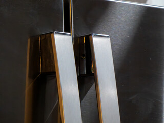 Metal door handles on stainless steel refrigerator doors