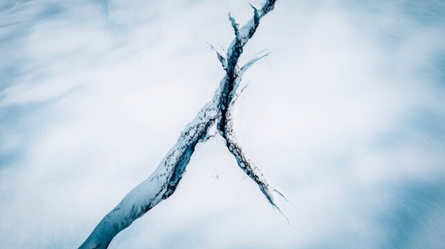 uriel. Aerial view of a deep lightning-shaped crack splitting a smooth glacier surface. travel magazines, destination branding, designed for travel destination branding, used by lab technicians.
