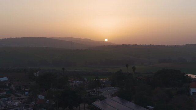 Kafr Misr and Ein Dor in Israel are framed by the vibrant colors of a winter sunset above the hills.
