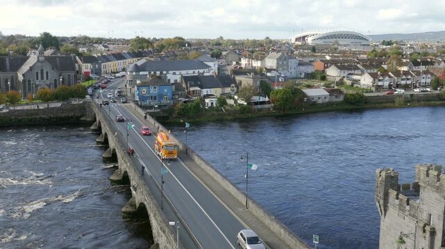Limerick, Ireland skyline with Saint Munchin's Church on the River Shannon by the Thomond Bridge. As seen from King John's Castle on a sunny day. Thomond Park rugby stadium in background.