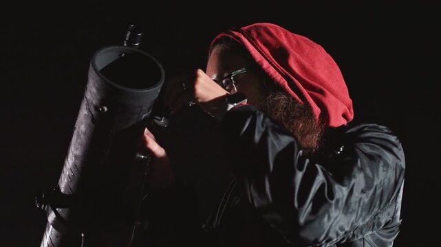 Star gazer amateur equipment. Night observer with telescope equipment. Amateur stargazer adjusting eyepiece under night sky. Person with glasses observing stars through telescope in darkness