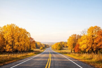 Scenic highway through vibrant autumn forest with golden trees and clear blue sky