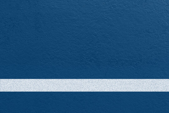 Tennis court surface background with blue textured ground and a clean white court line