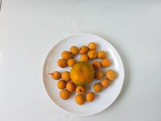 Fototapeta premium longan fruit on a plate isolate on white background