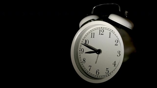 Tme lapse video of a clock time passing over a day to night on black background.