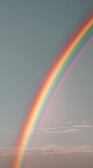 Fototapeta premium Colorful rainbow arching across a blue sky with wispy clouds 