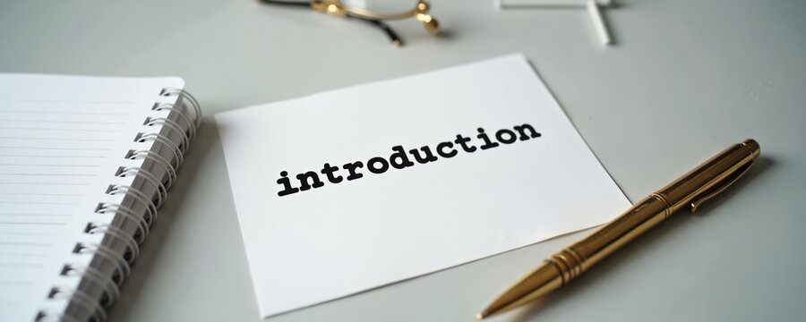 Paper with word introduction sits on office desk beside pen and notebook. Blank paper waits for notes or plan. Ready for new task, project start, or business idea.