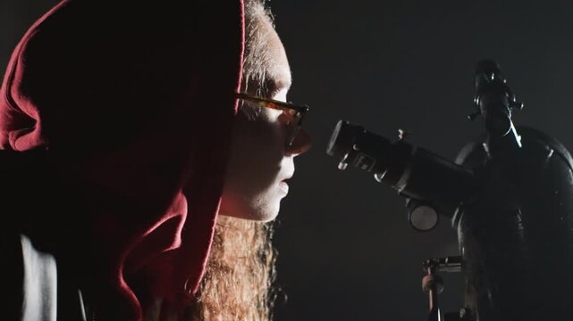 night telescope stargazer checks star charts, closeup of hands flipping pages and calibrating eyepiece, logbook entries under flashlight, focused researcher in hood, procedural mood with data driven