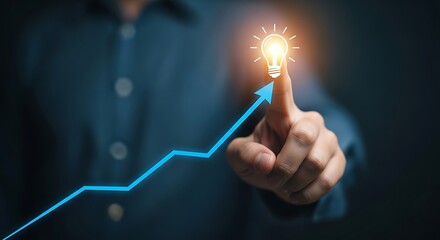 Man's finger touching upward trend line and glowing light bulb, symbolizing success, innovation, and growth