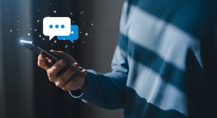 A person holding a smartphone with a chat bubble on the screen