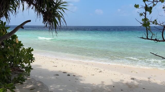 Ukulhas beach Maldives with white sand shoreline and calm turquoise ocean