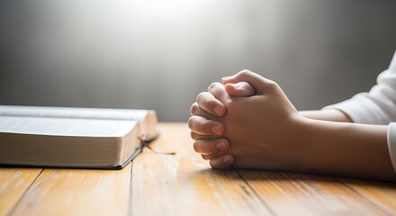 Hands Clasped in Prayer with an Open Bible on a Wooden Table, Symbolizing Faith, Hope, Spirituality, and Devotion