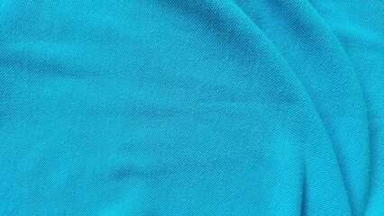 Close up blue football jersey fabric texture. Soft blue sports clothing material background. Sports wear background with detailed textile pattern.