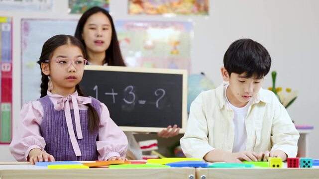 Thai Elementary Teacher Teaching Mathematics Addition to Students in Classroom